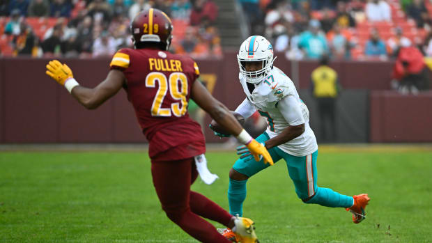 Dec 3, 2023; Landover, Maryland, USA; Miami Dolphins wide receiver Jaylen Waddle (17) runs after a catch as Washington Commanders cornerback Kendall Fuller (29) looks on during the second half at FedExField. Mandatory Credit: Brad Mills-USA TODAY Sports