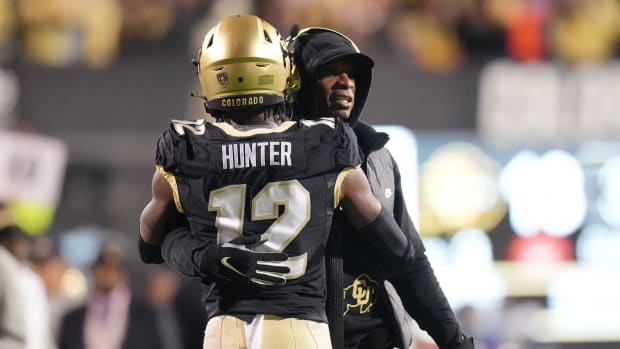 Colorado Buffaloes wide receiver Travis Hunter (12) is congratulated for his touchdown by head coach Deion Sanders in the first quarter against the Stanford Cardinal at Folsom Field